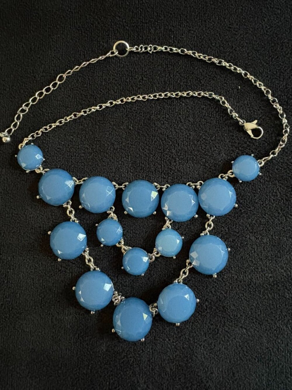 Statement necklace with blue faceted stones on a silver chain